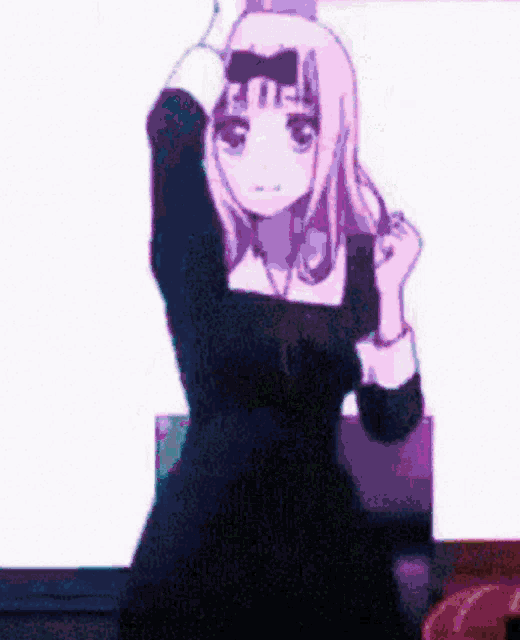 a girl in a black dress with a bow on her head is standing in front of a white background .