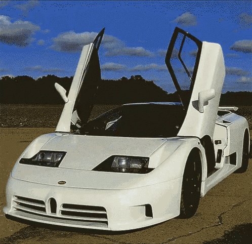 a white sports car with the doors open and the hood up