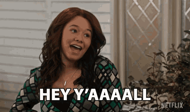 a woman with red hair says " hey y'aaall "