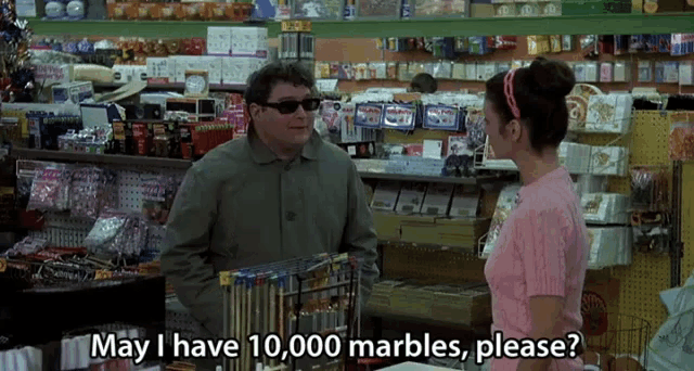 a woman in a pink shirt asks a man in a store if they have 10,000 marbles