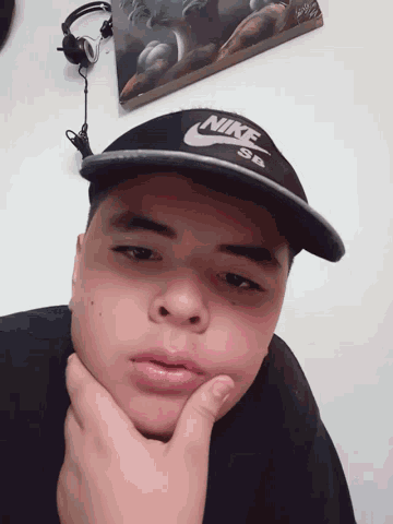 a boy wearing a nike hat laying down
