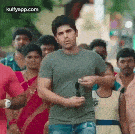 a man is running through a crowd of people .