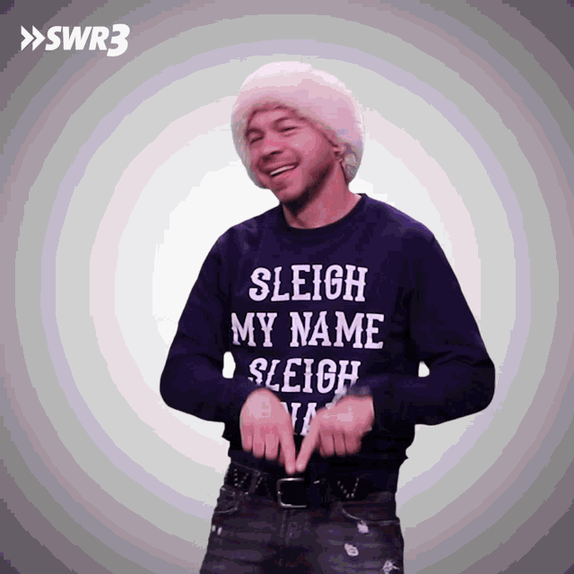 a man is wearing a sweater that says sleigh my name sleigh