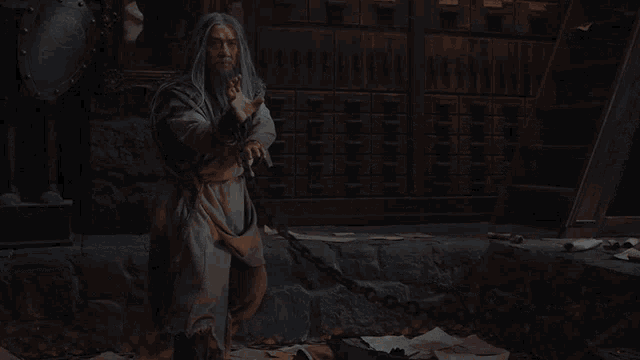 a man with long hair and a beard is chained to a staircase