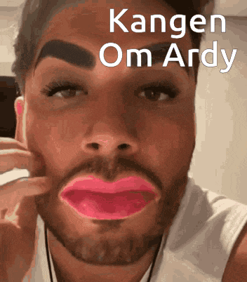 a man with a beard is wearing pink lipstick and has kangen om ardy written on his face