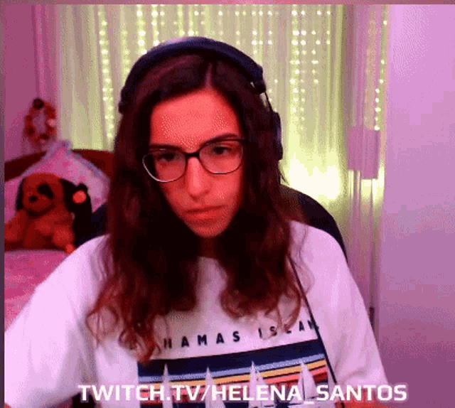 a woman wearing headphones and a shirt that says ' twitch.tv/helena_santos '