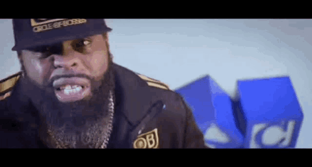 a man with a beard wearing a hat that says circle of bosses on it