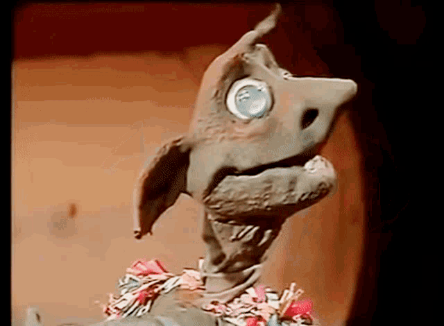 a close up of a puppet that looks like a chicken