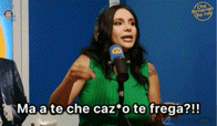 a woman in a green top is talking into a microphone and says ma a te che caz o te frega !!!
