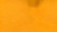 a shadow of a person holding a shield is cast on a yellow surface