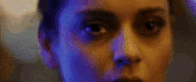 a close up of a woman 's face with a tear in her eye .