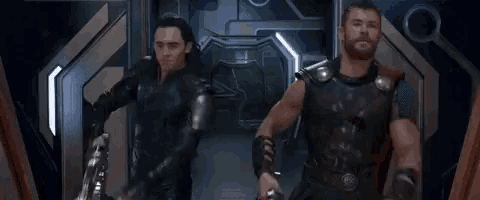 thor and loki are standing next to each other in a hallway with the words hello written on the wall
