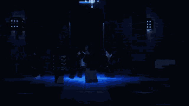 a group of people are standing in a dark room with a blue light shining on them