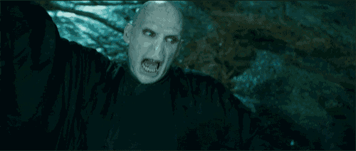 a man with a bald head is crawling in the dark