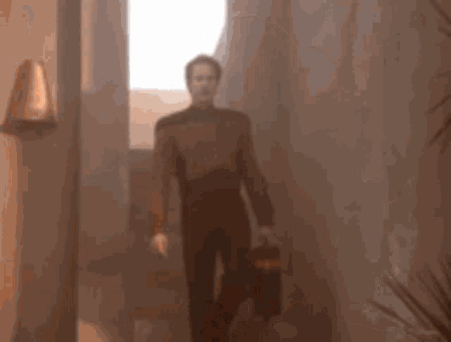 a man in a brown uniform is making a funny face