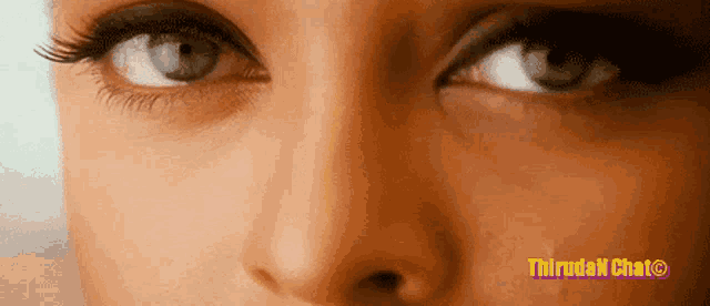 a close up of a woman 's eyes with the words thiruda chat written on the bottom