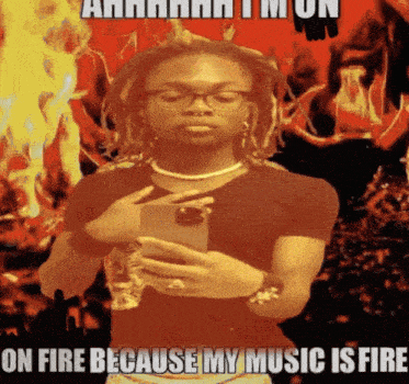 a man taking a picture of himself with the words on fire because my music is fire