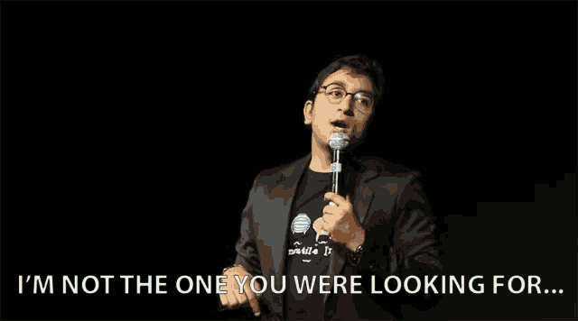 a man speaking into a microphone with the words " i 'm not the one you were looking for " below him