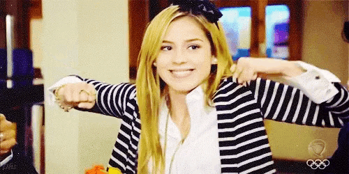 a woman wearing a striped cardigan and a bow on her head