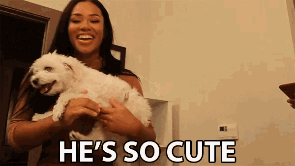 a woman holding a small white dog with the words he 's so cute written below her