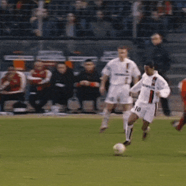 a soccer player wearing number 10 is kicking the ball