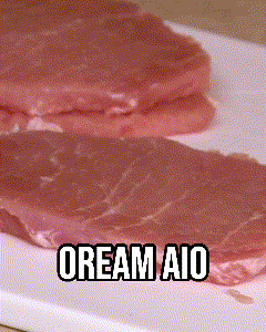 two pieces of meat on a white cutting board with the words cream aio written below them
