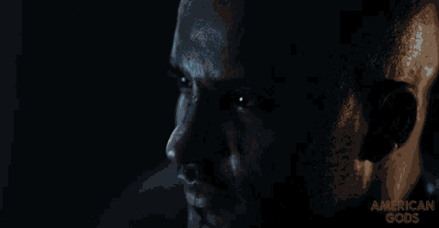 a close up of a man 's face with the words american gods on the bottom right