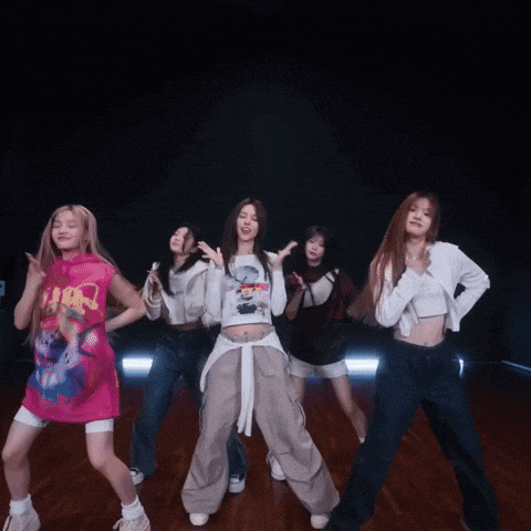 a group of girls are dancing together and one of them is wearing a shirt that says ' i am '
