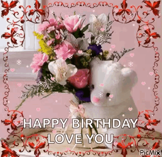 a teddy bear is sitting next to a bouquet of flowers and says `` happy birthday love you '' .