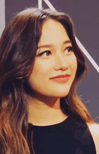 a close up of a woman 's face with a black shirt on