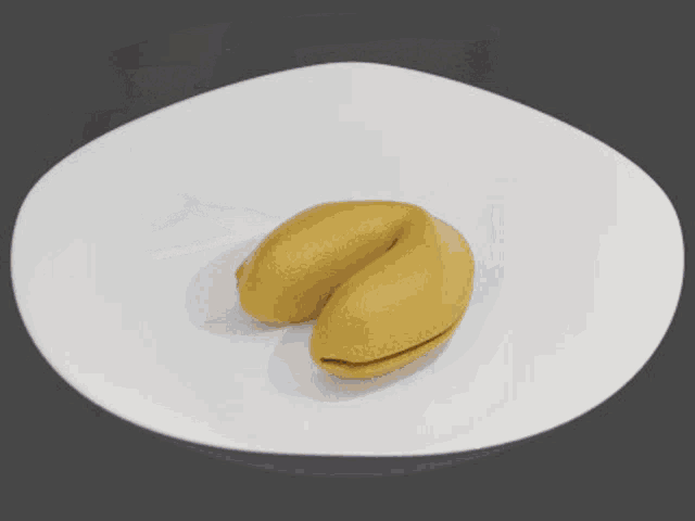 a gold fortune cookie with a black and white photo of a skeleton on it