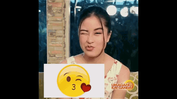 a girl is making a funny face with a smiley face behind her that says 3 on it