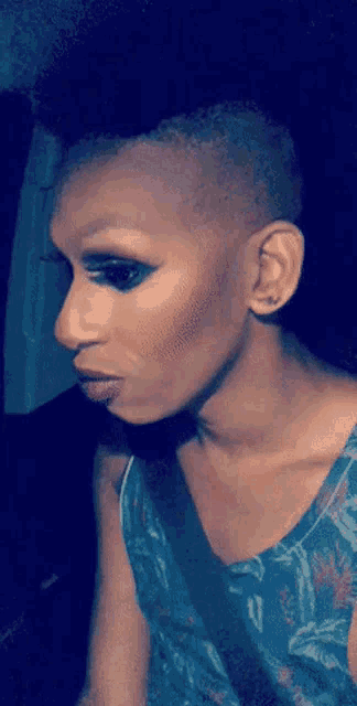 a close up of a woman 's face with a shaved head