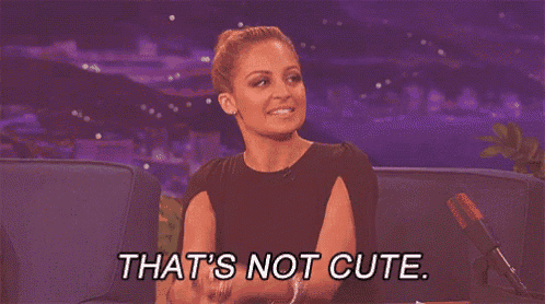 a woman is sitting on a couch and says that 's not cute .