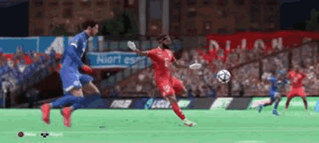 a soccer player in a red jersey is kicking the ball while another player in a blue jersey tries to stop him .