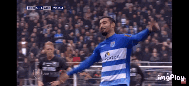 a soccer player wearing a blue and white jersey that says alcatel
