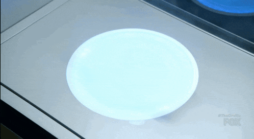 a white plate is sitting on a counter with the fox logo on the bottom