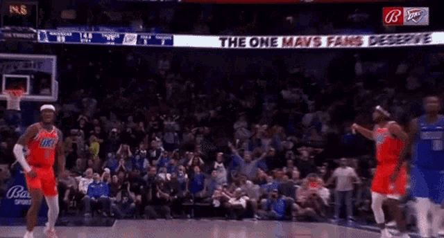 a basketball game is being played in front of a crowd with a sign that says " the one mavs fans despise "