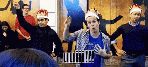 a group of men wearing crowns are dancing in a room with the word unity written in black