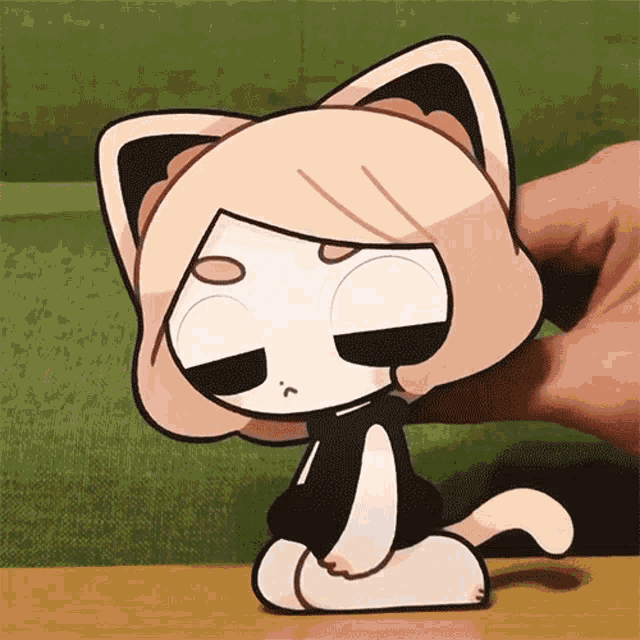 a person is holding a cartoon cat with a sad look on its face