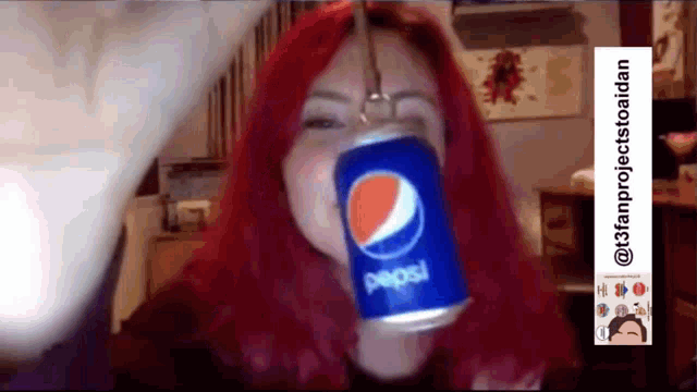 a woman with red hair is drinking a pepsi can .