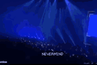 a man singing into a microphone with the words " i don 't give a shit " on the bottom right