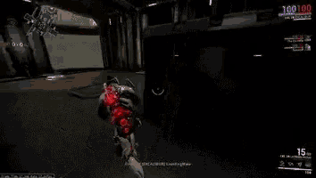 a person is playing a video game in a room with a red light coming out of it .