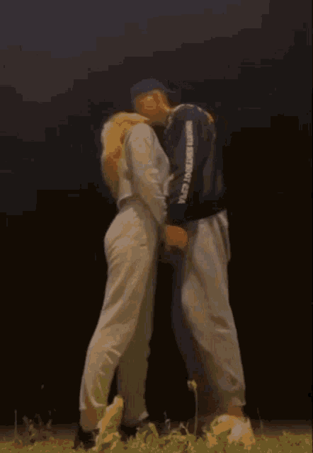 a man and a woman are kissing and the man is wearing a sweatshirt that says united states army corp