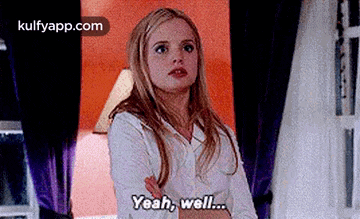 a woman is standing in front of a window with her arms crossed and says `` yeah , well ... '' .