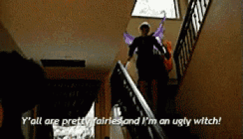 a man in a fairy costume is walking down a set of stairs ..