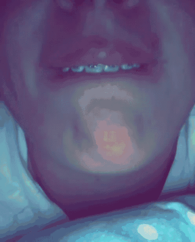 a close up of a person 's face with a red spot on their lip