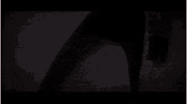 a close up of a person wearing a helmet and goggles in a dark room .