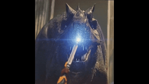 a close up of a dragon with a light coming out of it 's mouth