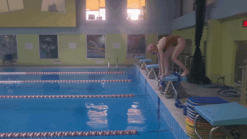 a swimming pool with a sign that says ' swimming ' on the side